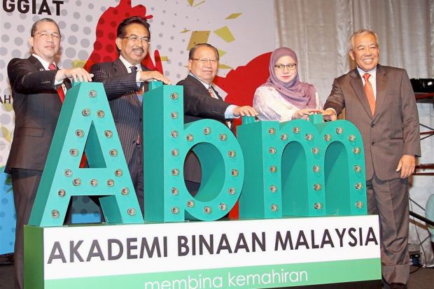 Musa (second from left) with Fadillah (left) officiating at the graduation ceremony of the Malaysia Construction Academy.