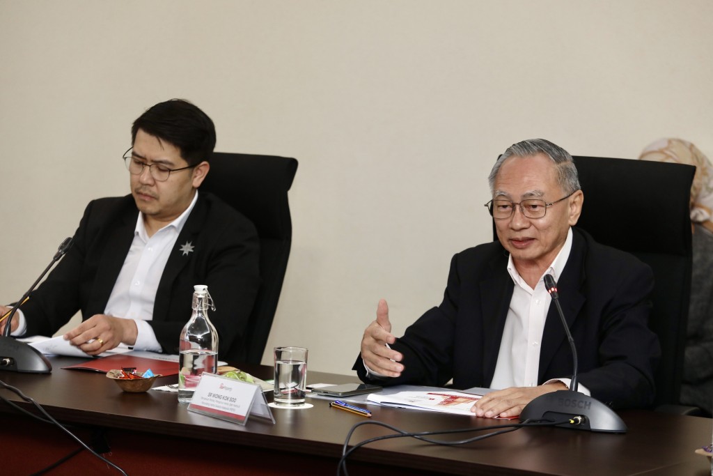 Wong (right) makes a point while Hoi (left) reads the discussion materials.—Low Lay Phon/The Star